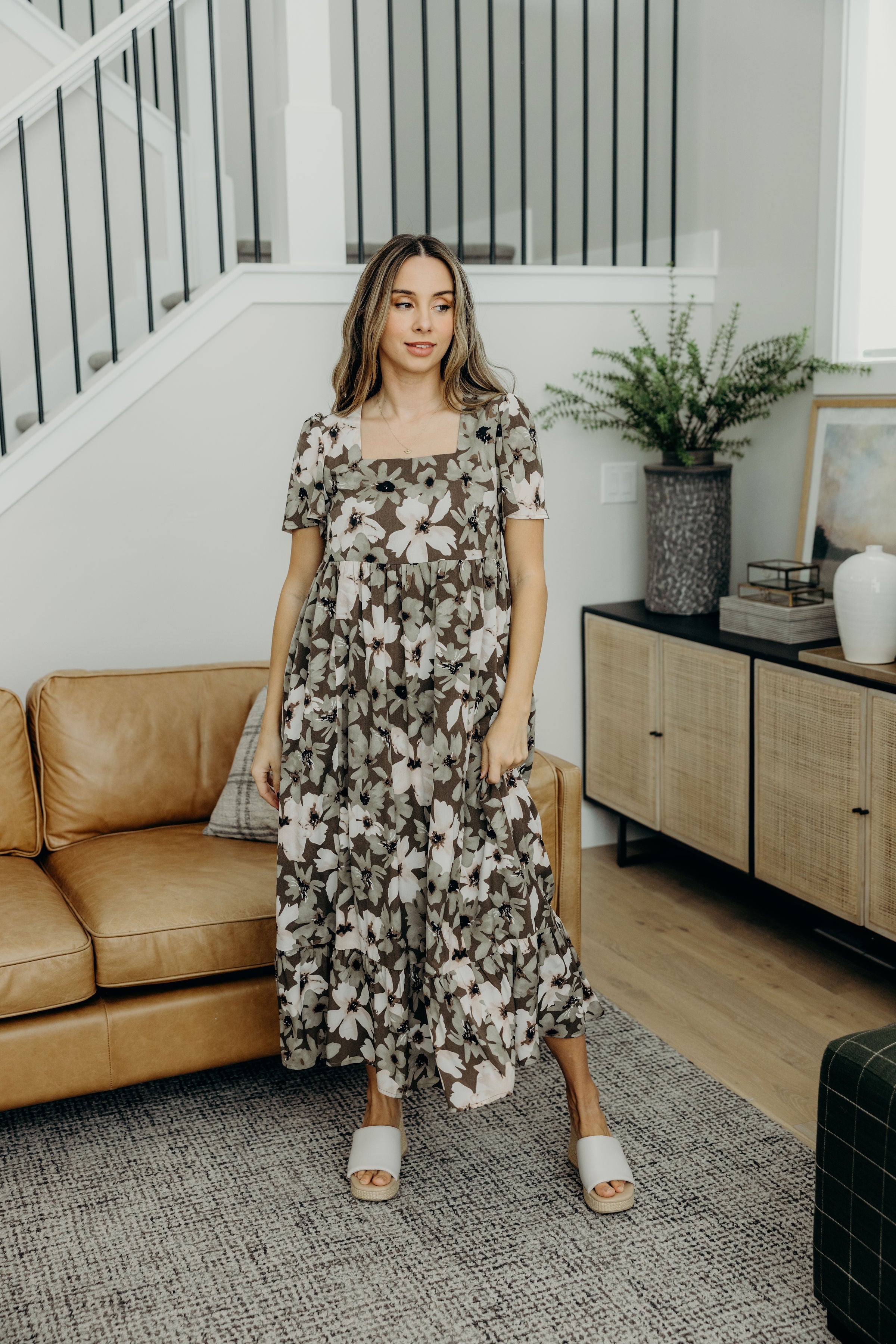 Midi length dress with ruffle hem, empire waist, square neckline, and short sleeves.