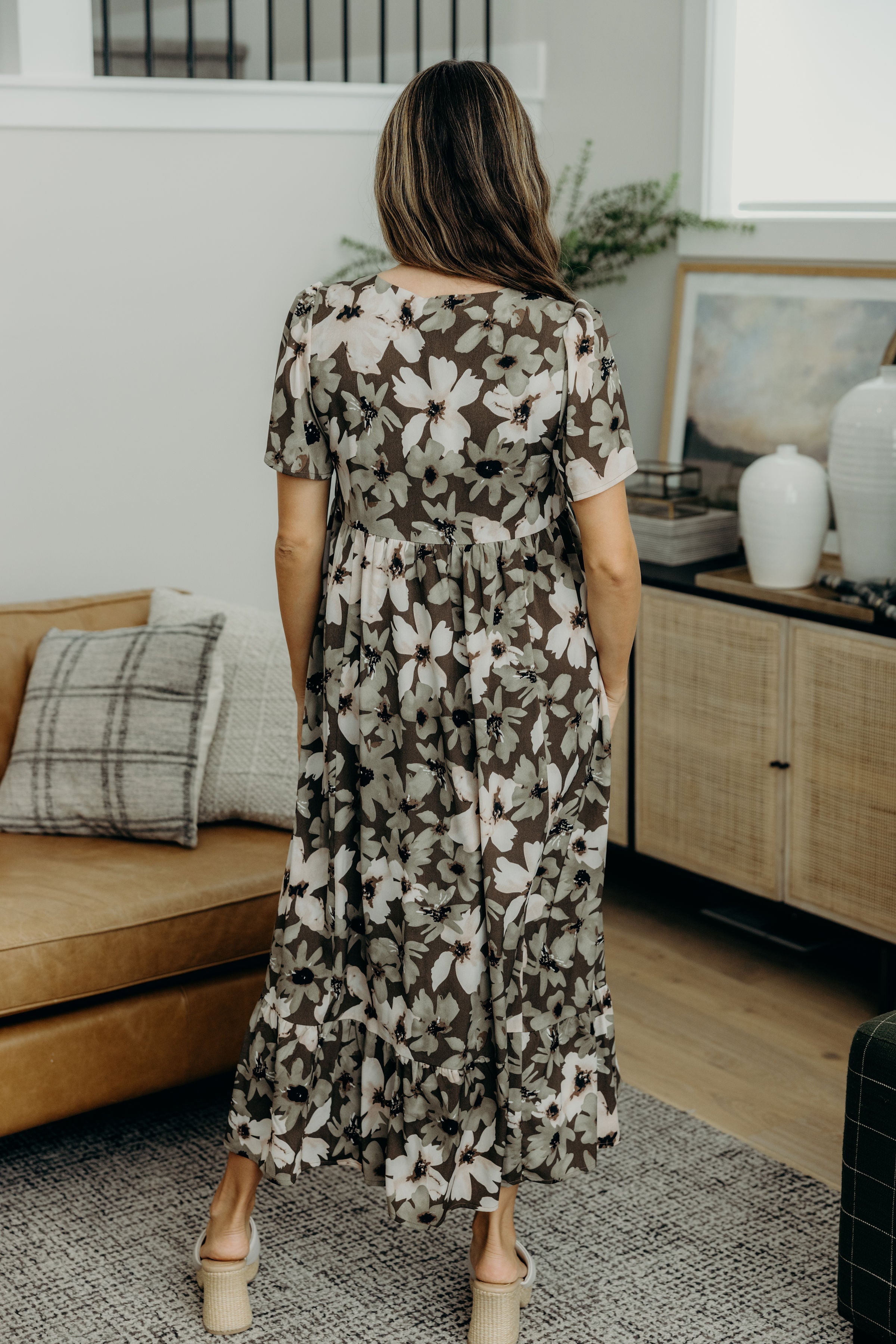 Back view of of green print midi dress with ruffle hem.