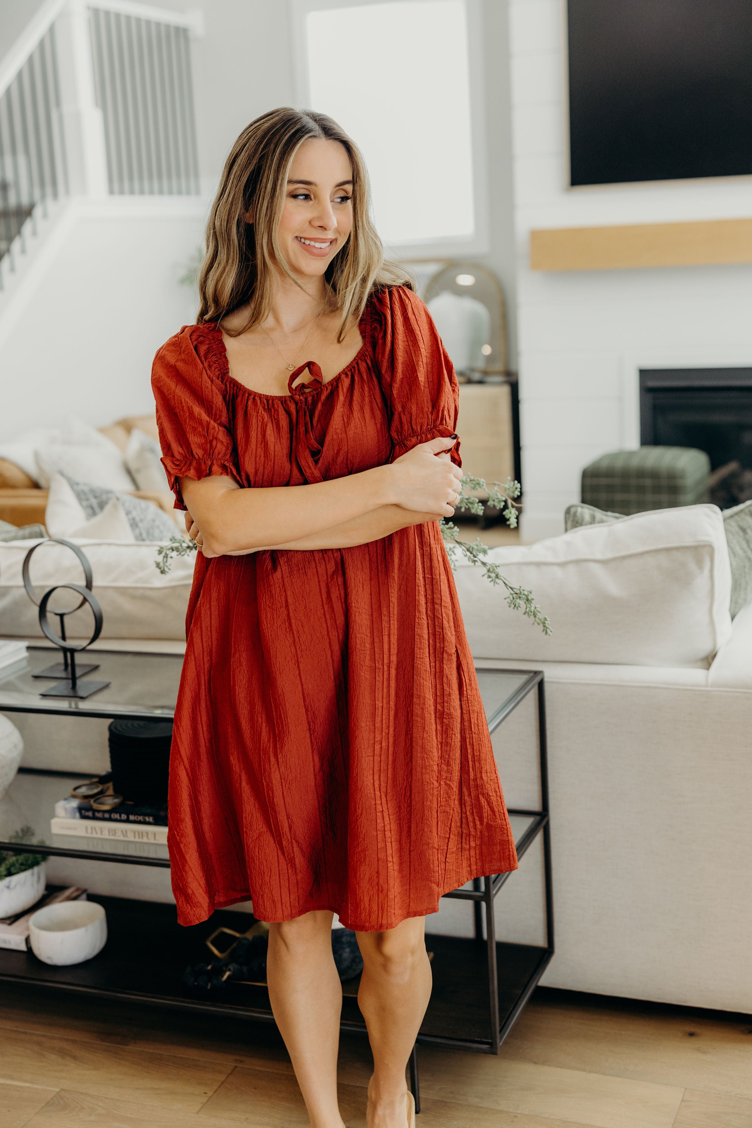 Red textured shift dress with square neckline with tie detail and half sleeves.