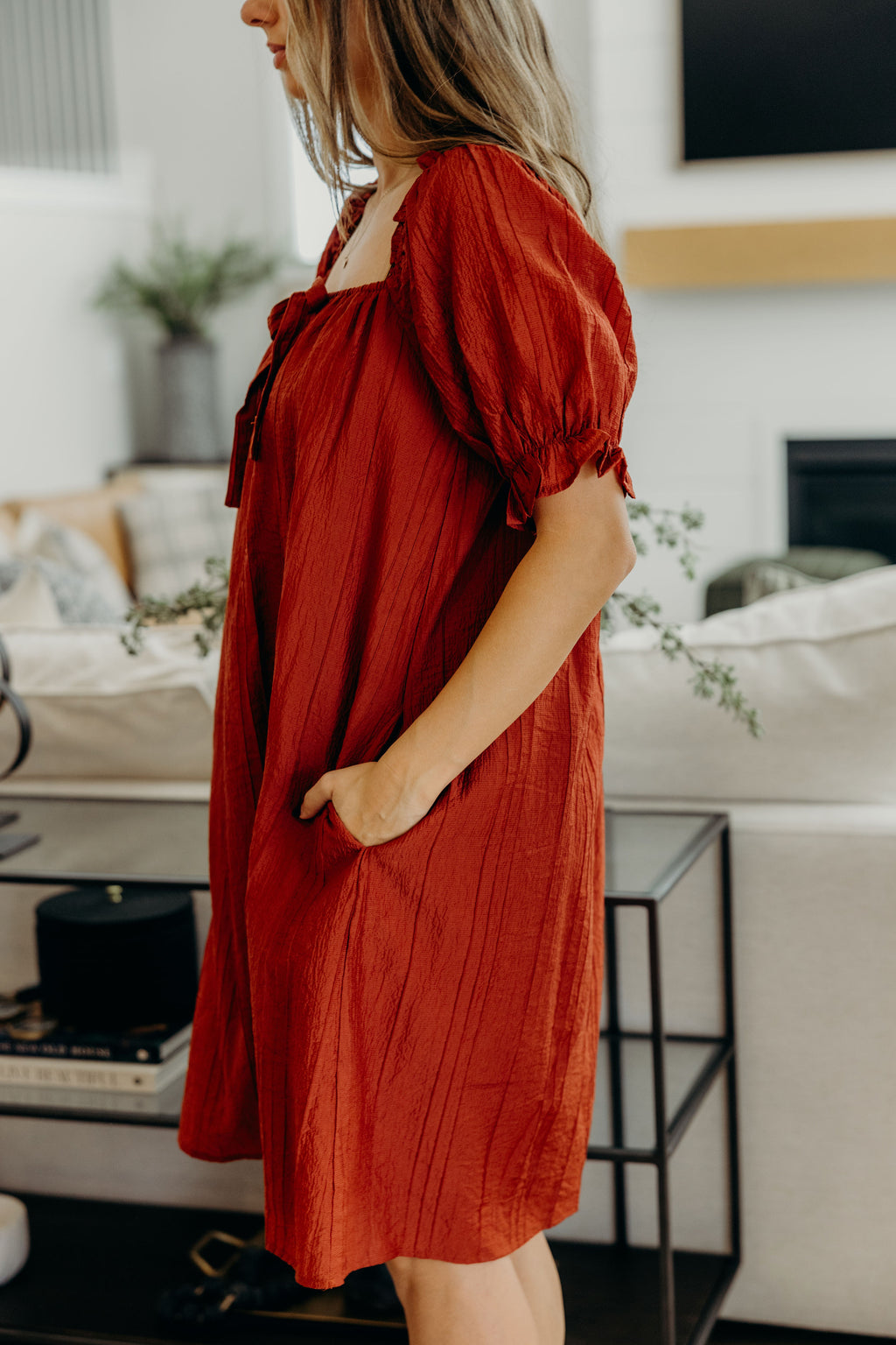 Red textured shift dress with tie detail, half sleeve, and pockets.