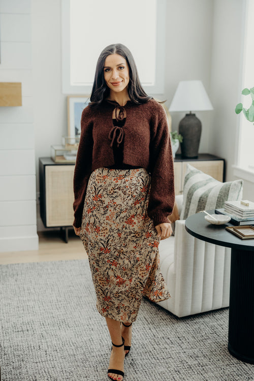 Reddish brown cropped sweater with bow closures.