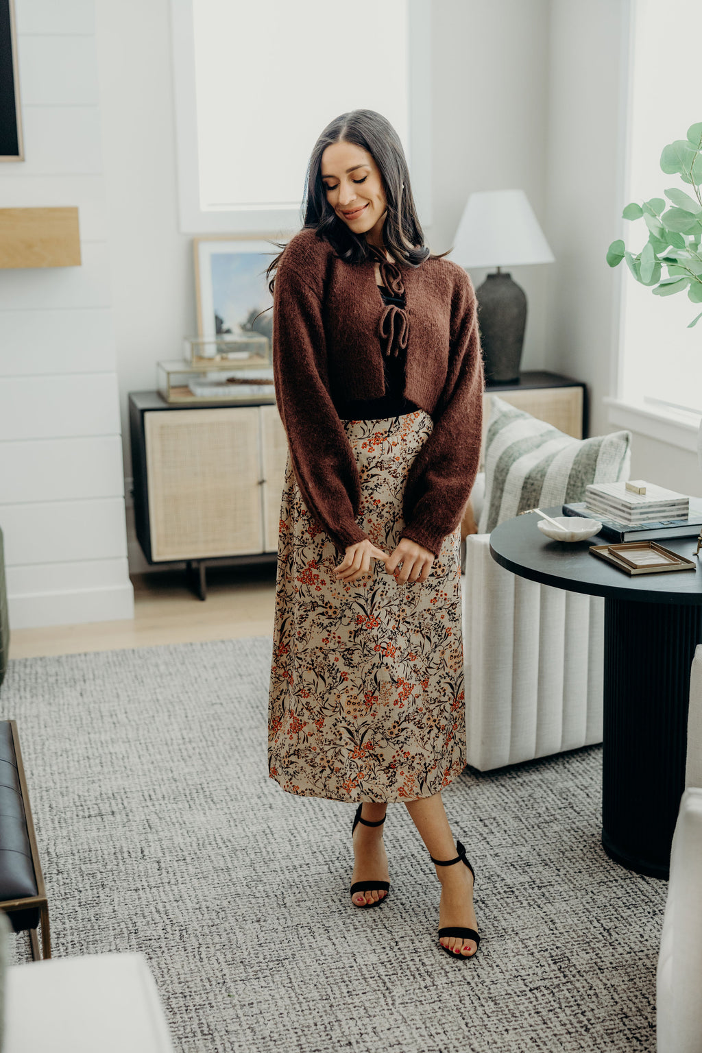 midi length tan skirt with autumnal print with straight silhouette.