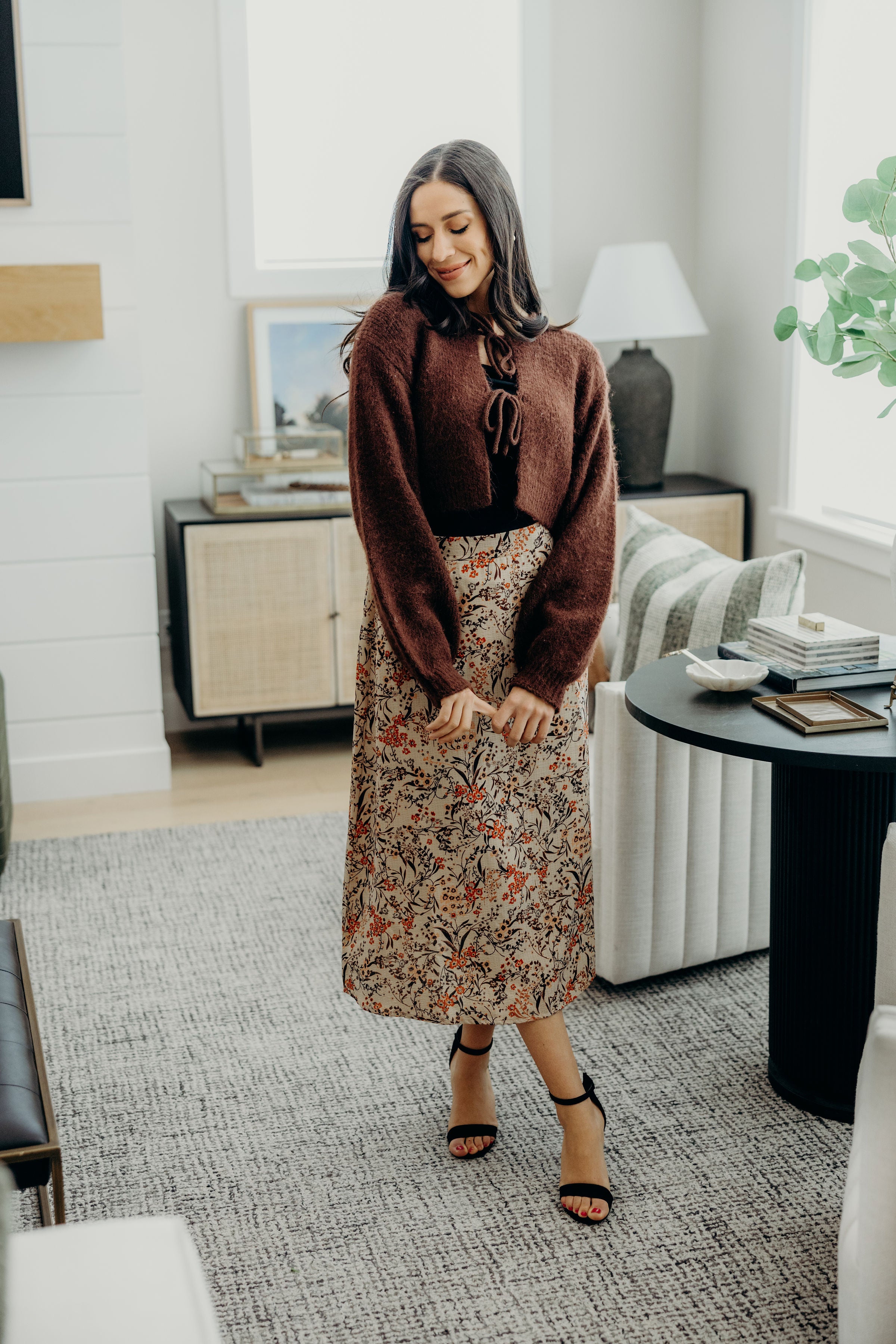 midi length tan skirt with autumnal print with straight silhouette.