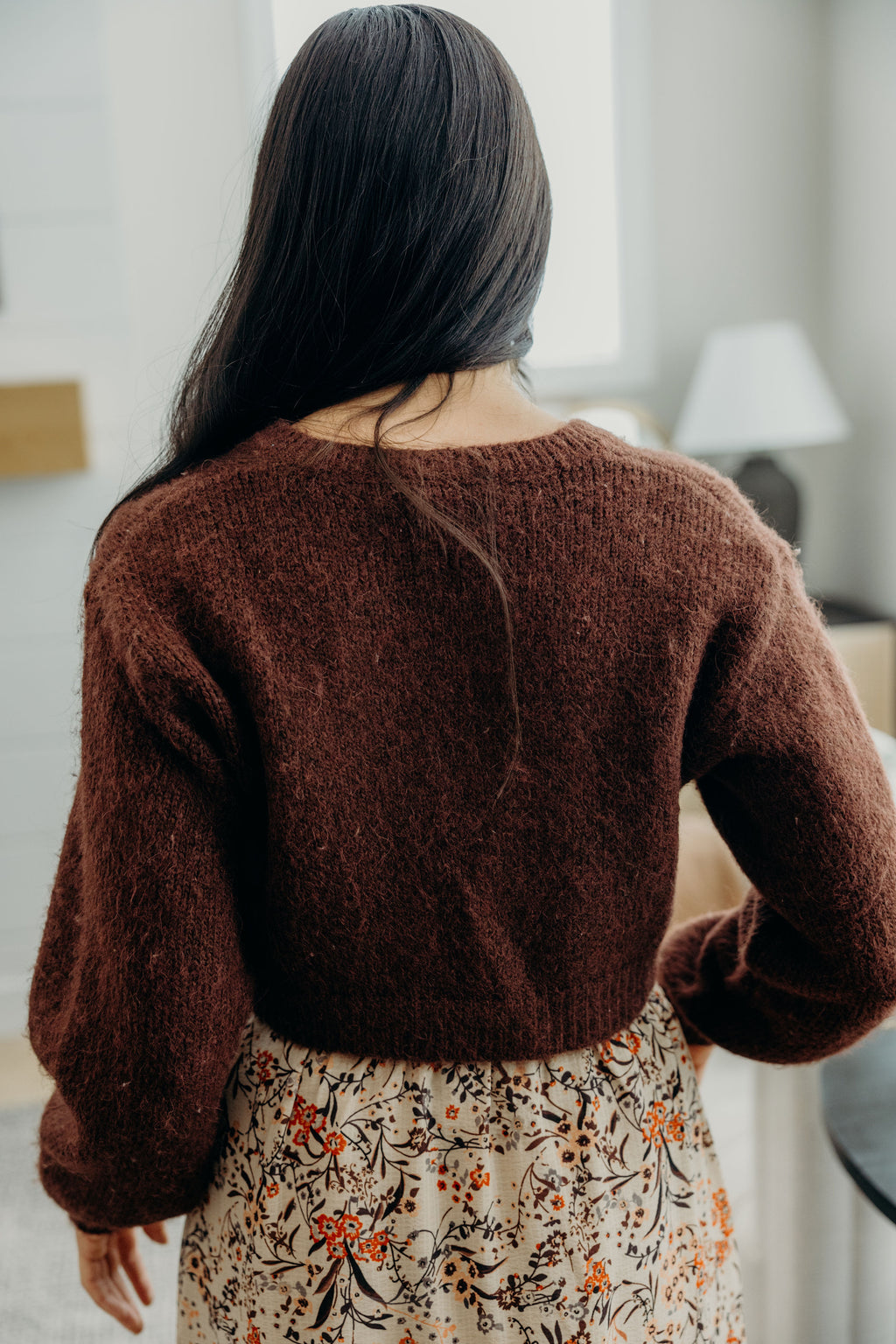 Back view of reddish brown cropped knit sweater.