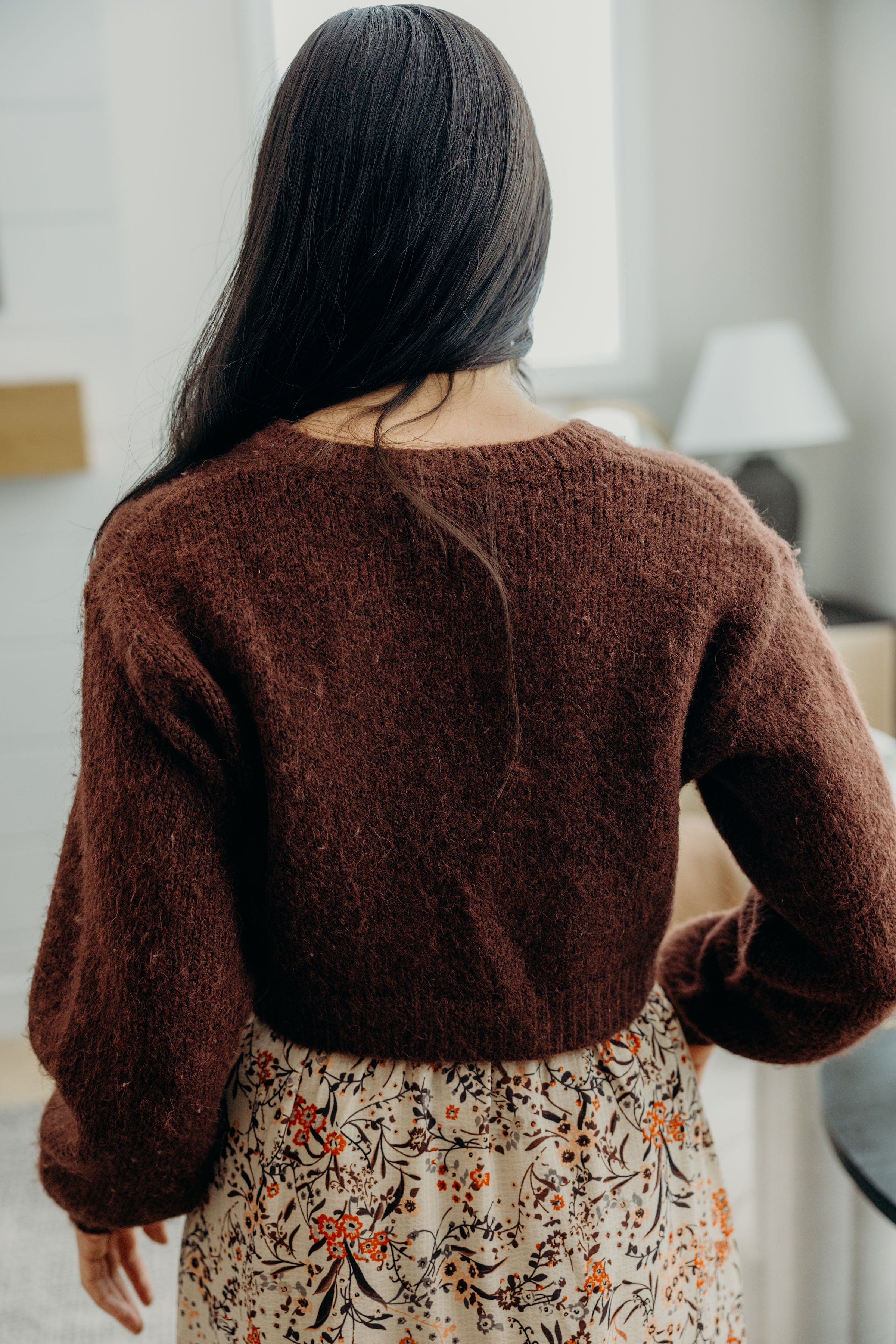Back view of reddish brown cropped knit sweater.